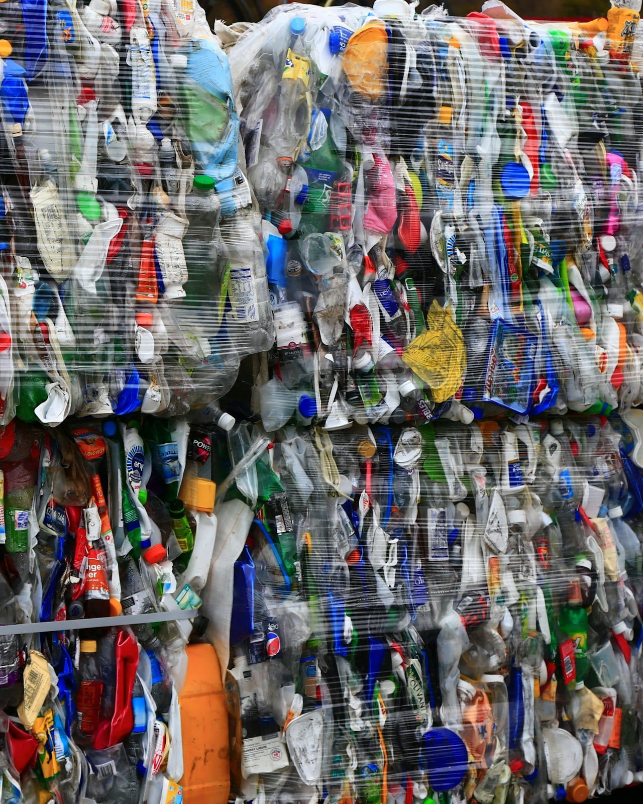 Bales of used plastic bottles and containers pressed for recycling